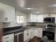 Bright kitchen with white cabinetry, stainless steel dishwasher, and stylish countertops at 2721 E Beverly Ln, Phoenix, AZ 85032