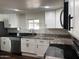 Contemporary kitchen design with sleek white cabinets, stainless appliances, and granite countertops at 2721 E Beverly Ln, Phoenix, AZ 85032