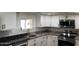 Modern kitchen featuring white cabinets, stainless steel appliances, and granite countertops at 2721 E Beverly Ln, Phoenix, AZ 85032