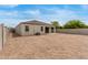 Expansive backyard with gravel landscaping and a covered patio, offering a blank canvas for outdoor enjoyment at 30390 W Mitchell Ave, Buckeye, AZ 85396