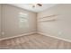 Comfortable bedroom with a window for natural light and wall shelving at 30390 W Mitchell Ave, Buckeye, AZ 85396