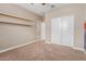 Cozy bedroom with plush carpeting, shelving and a closet with sliding doors at 30390 W Mitchell Ave, Buckeye, AZ 85396
