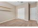 Neutral bedroom with wall shelving and closet featuring sliding doors at 30390 W Mitchell Ave, Buckeye, AZ 85396
