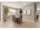 Bright dining room area with neutral walls, tile floors, and large window at 30390 W Mitchell Ave, Buckeye, AZ 85396