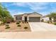 Charming single-story home with a well-maintained landscape and a two-car garage at 30390 W Mitchell Ave, Buckeye, AZ 85396