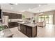 Open kitchen with stainless steel appliances, a granite island, and seamless flow to living area at 30390 W Mitchell Ave, Buckeye, AZ 85396