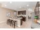 Stylish kitchen with a center island, bar seating, and stainless steel appliances at 30390 W Mitchell Ave, Buckeye, AZ 85396