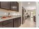 Modern kitchen features granite countertops, stainless steel appliances, and dark cabinets at 30390 W Mitchell Ave, Buckeye, AZ 85396
