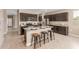 Modern kitchen with dark cabinets, granite countertops, and a stainless steel appliance package at 30390 W Mitchell Ave, Buckeye, AZ 85396