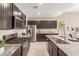 Well-equipped kitchen featuring stainless steel appliances, granite countertops, and ample cabinet space at 30390 W Mitchell Ave, Buckeye, AZ 85396