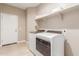 Well-lit laundry room with washer and dryer at 30390 W Mitchell Ave, Buckeye, AZ 85396