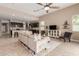 Inviting living room with comfortable seating, a ceiling fan, and an open layout to the kitchen at 30390 W Mitchell Ave, Buckeye, AZ 85396