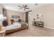 Serene main bedroom showcasing ceiling fan, wood bed frame, and carpet floors at 30390 W Mitchell Ave, Buckeye, AZ 85396