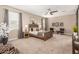 Cozy main bedroom with natural light, ceiling fan, and soft carpet at 30390 W Mitchell Ave, Buckeye, AZ 85396