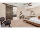 Well-lit main bedroom featuring a barn door leading to the ensuite bathroom at 30390 W Mitchell Ave, Buckeye, AZ 85396