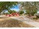 Community playground with slides, swings, and climbing structures surrounded by mature trees and green spaces at 30390 W Mitchell Ave, Buckeye, AZ 85396