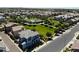Beautiful aerial view of a light blue two-story home in a community with a pool and green space at 324 N 56Th Pl, Mesa, AZ 85205