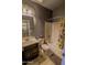 This bathroom has a shower-tub combo and vanity with decorative lighting at 324 N 56Th Pl, Mesa, AZ 85205