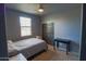 Cozy bedroom offers a neutral palette, closet and bright window at 324 N 56Th Pl, Mesa, AZ 85205
