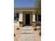 Inviting home entrance with a stone paver walkway and a covered front porch with decorative columns at 324 N 56Th Pl, Mesa, AZ 85205