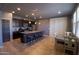 Modern kitchen featuring granite countertops, an island with seating, and stainless steel appliances at 324 N 56Th Pl, Mesa, AZ 85205