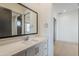 Modern bathroom vanity with white marble countertop and dark framed mirror at 3332 S Quinn Ave, Gilbert, AZ 85297