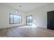 Sunlit room with wood floors, large window and sliding door to backyard at 3332 S Quinn Ave, Gilbert, AZ 85297