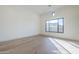 Bright bedroom featuring wood floors and a large window for natural light at 3332 S Quinn Ave, Gilbert, AZ 85297