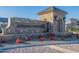 Elegant stone sign marks the entrance to Atrium at Somerset with manicured landscaping and stone guard house at 3332 S Quinn Ave, Gilbert, AZ 85297