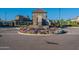 Stone gatehouse guards a circle of flowers at the entrance to a community with well-kept homes at 3332 S Quinn Ave, Gilbert, AZ 85297