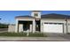 New home with a modern design, two car garage, beautiful lawn and desert landscaping in front at 3332 S Quinn Ave, Gilbert, AZ 85297