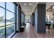 Well-lit hallway with large windows, wood floors, stylish decor, and comfortable seating area at 3332 S Quinn Ave, Gilbert, AZ 85297