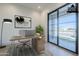 Virtually staged home office with desk, artwork and backyard view at 3332 S Quinn Ave, Gilbert, AZ 85297