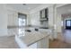 Spacious kitchen features white cabinets, a marble island, stainless appliances, and tiled backsplash at 3332 S Quinn Ave, Gilbert, AZ 85297