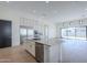 Expansive kitchen with stainless appliances, a marble island, white cabinets, and a view to the backyard at 3332 S Quinn Ave, Gilbert, AZ 85297