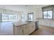 Bright kitchen with a marble island countertop, white cabinets, tile backsplash, and stainless appliances at 3332 S Quinn Ave, Gilbert, AZ 85297