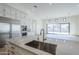 Modern kitchen boasts marble counters, stainless steel appliances, and ample cabinet space, all within an open floor plan at 3332 S Quinn Ave, Gilbert, AZ 85297