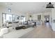 Virtually staged bright living room featuring open floor plan with modern kitchen and hardwood floors at 3332 S Quinn Ave, Gilbert, AZ 85297