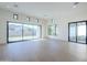 Spacious living room featuring large windows, sliding glass doors, and hardwood floors, providing ample natural light at 3332 S Quinn Ave, Gilbert, AZ 85297