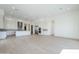 Open floorplan with bright kitchen with white cabinets, large island, and spacious living area with hardwood floors at 3332 S Quinn Ave, Gilbert, AZ 85297