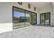 Covered patio with stone flooring and large sliding glass doors at 3332 S Quinn Ave, Gilbert, AZ 85297