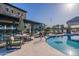 Community pool area featuring clear blue water, umbrellas, and lounge seating at 3332 S Quinn Ave, Gilbert, AZ 85297