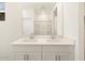 Bright bathroom featuring a double vanity and a shower with glass doors at 335 S San Gregorio Ln, Casa Grande, AZ 85194