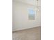 Light-filled room with neutral tile flooring and a modern chandelier at 335 S San Gregorio Ln, Casa Grande, AZ 85194