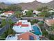 Stunning aerial view of a property featuring a private pool, lush landscaping, and serene mountain backdrop at 3417 E Mission E Ln, Phoenix, AZ 85028