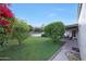 Lush backyard featuring a well-manicured lawn, landscaping, and a patio area at 3417 E Mission E Ln, Phoenix, AZ 85028