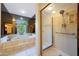 Well-lit bathroom featuring a glass-door shower, soaking tub and unique window at 3417 E Mission E Ln, Phoenix, AZ 85028