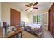 Cozy bedroom featuring a ceiling fan, light colored walls, and a view to the backyard through the window at 3417 E Mission E Ln, Phoenix, AZ 85028