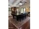 Open dining room featuring vaulted ceilings, a fireplace, a ceiling fan, and views to the kitchen at 3417 E Mission E Ln, Phoenix, AZ 85028