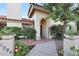 Charming home exterior featuring an arched entrance, lush landscaping, and a well-manicured walkway at 3417 E Mission E Ln, Phoenix, AZ 85028